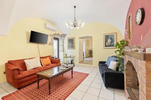 a living room with a couch and a fireplace at Affittacamere Le Muse in Scano Montiferro