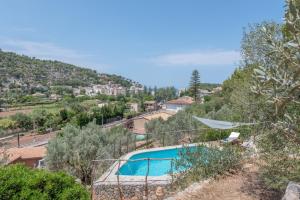 a swimming pool in the middle of a hill at Villa Cami de la Mar in Port de Soller