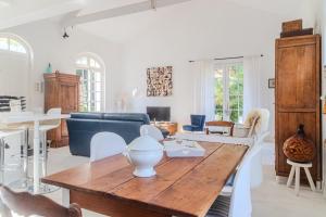 a living room with a table and a couch at Villa au bord de la Charente in Jarnac +25 photos