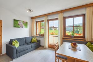 a living room with a couch and a table at Ratschingser Kreuz Blasighof in Racines