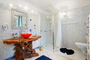 a bathroom with a wooden sink and a shower at Villa Les Dauphins in Le Lavandou +38 photos