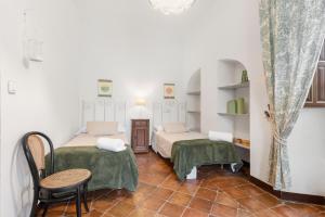 a room with two beds and a table and chairs at Cortijo Caracate in Archidona +26 photos