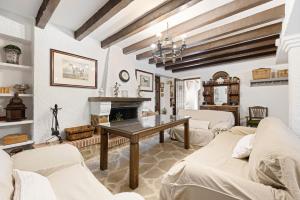 a living room with a table and a fireplace at Cortijo Caracate in Archidona