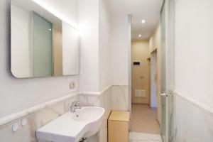 a white bathroom with a sink and a mirror at Le scale, borgo dei pescatori in Cervo