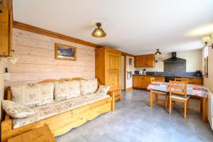 a living room with a couch and a table at Chalet La Sportive in Cornimont