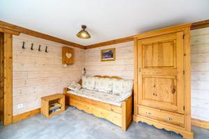 a sauna with a bench and a wooden wall at Chalet La Sportive in Cornimont