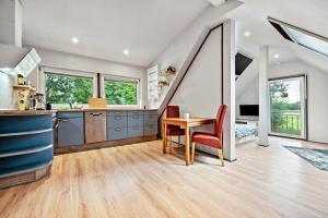 a kitchen with a table and chairs in a room at Zum Kanal in Steinau