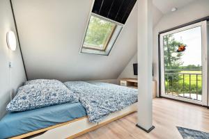 a bedroom with a bed and a large window at Zum Kanal in Steinau