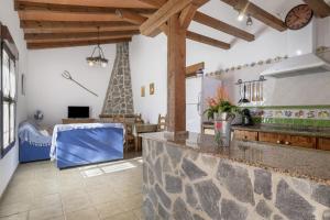 a kitchen with a stone counter top in a room at Cortijo Entrepinares in Conil de la Frontera