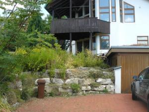 a house with a balcony on the side of it at Ferienwohnung Naturhaus, 50qm in Allensbach +15 photos