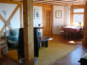 a living room with a table and a dining room at Ferienwohnung Naturhaus, 50qm in Allensbach