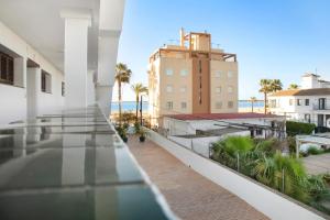 a balcony with a view of the ocean and buildings at Sol y mar in Sanlúcar de Barrameda