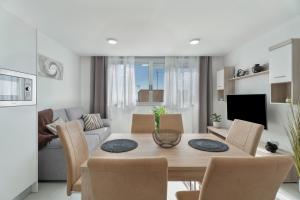 a dining room and living room with a table and chairs at Apartamento Iris Tropical in Araya +12 photos