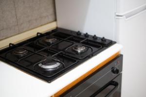 a stove top oven sitting inside of a kitchen at La Capannuccia C in Ansedónia +5 photos