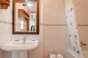 a bathroom with a sink and a mirror at Villa Gallardo in Campillos +13 photos