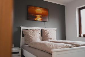 a bedroom with two beds and a painting on the wall at Ferienwohnungen Bullau - 2 in Erbach