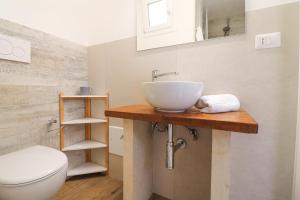 a bathroom with a sink and a toilet at Casa Sveva a Otranto vista mare in Otranto +11 photos