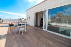 a balcony with a table and a view of a building at Casa Sveva a Otranto vista mare in Otranto