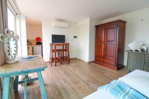 a room with a bed and a table and a kitchen at Casa Sveva a Otranto vista mare in Otranto