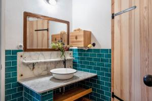 a bathroom with a sink and a mirror at Der Flusshof, Scheunenwohnung in Werben +26 photos