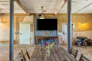 a large room with a table with flowers on it at Der Flusshof, Scheunenwohnung in Werben
