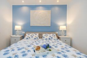 a blue bedroom with a bed with a tray of food on it at Isabel Beach and Bike in Finale Ligure