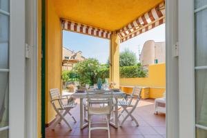 a dining room with a table and chairs on a patio at Isabel Beach and Bike in Finale Ligure