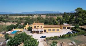 an aerial view of a large house with a pool at Les Cabretes Vilanova de la Muga in Vilanova de la Muga