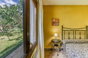 a bedroom with a bed and a large window at Les Cabretes Vilanova de la Muga in Vilanova de la Muga +37 photos