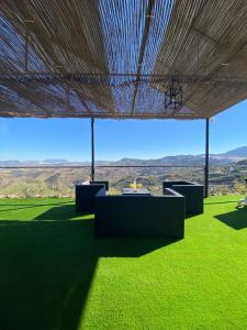 a view from under a roof on a field of grass at Miralvalle in El Gastor