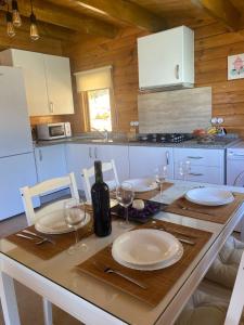 a kitchen with a table with plates and wine glasses at Miralvalle in El Gastor