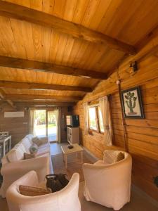 a living room with white furniture and wooden ceilings at Miralvalle in El Gastor