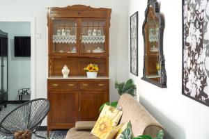 a living room with a couch and a wooden cabinet at Marisol' House in Puente Genil