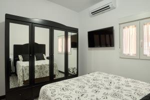 a bedroom with a bed and a mirror at Marisol' House in Puente Genil +23 photos