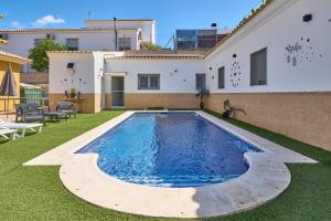 a swimming pool in the backyard of a house at Marisol' House in Puente Genil