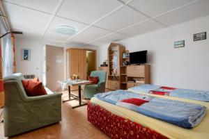 a bedroom with a bed and a table and chairs at Ferienbungalows Werner in Koserow