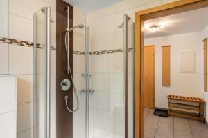 a shower with a glass door in a bathroom at Ferienwohnung Graf in Lauf +25 photos