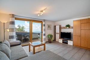 a living room with a couch and a tv at Ferienwohnung Graf in Lauf