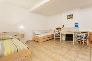 a bedroom with a bed and a desk and a fireplace at Maison Collo in Collobrières