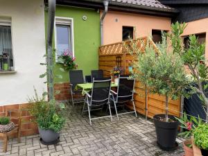 a patio with a table and chairs and plants at Haus Steffine in Annahütte
