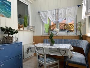 a kitchen with a table and chairs and a window at Haus Steffine in Annahütte