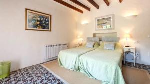 two beds in a room with white walls at Sol y Montes in Fornalutx +22 photos