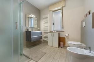 a bathroom with a sink and a toilet and a shower at Residenza Tambella in Verrès +21 photos