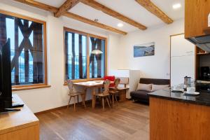 a kitchen and living room with a table and chairs at Schloss Gravetsch in Villandro