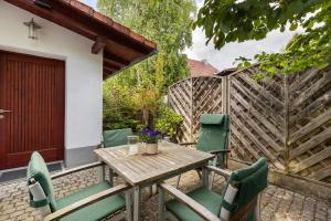 a wooden table and chairs on a patio at Ferienwohnung an der Brigach in Donaueschingen