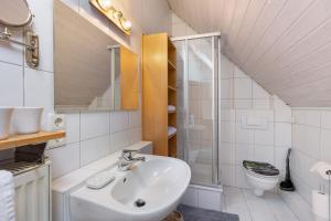 a bathroom with a sink and a shower and a toilet at Ferienwohnung an der Brigach in Donaueschingen +15 photos