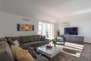 a living room with a couch and a table at Modern penthouse in Fuengirola