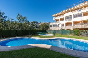 a swimming pool in front of a building at Modern penthouse in Fuengirola
