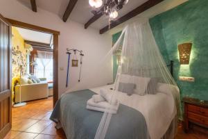 a bedroom with a bed with a mosquito net at La Casa Al Revés in Laroya +18 photos