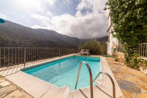 a swimming pool with a view of a mountain at La Casa Al Revés in Laroya